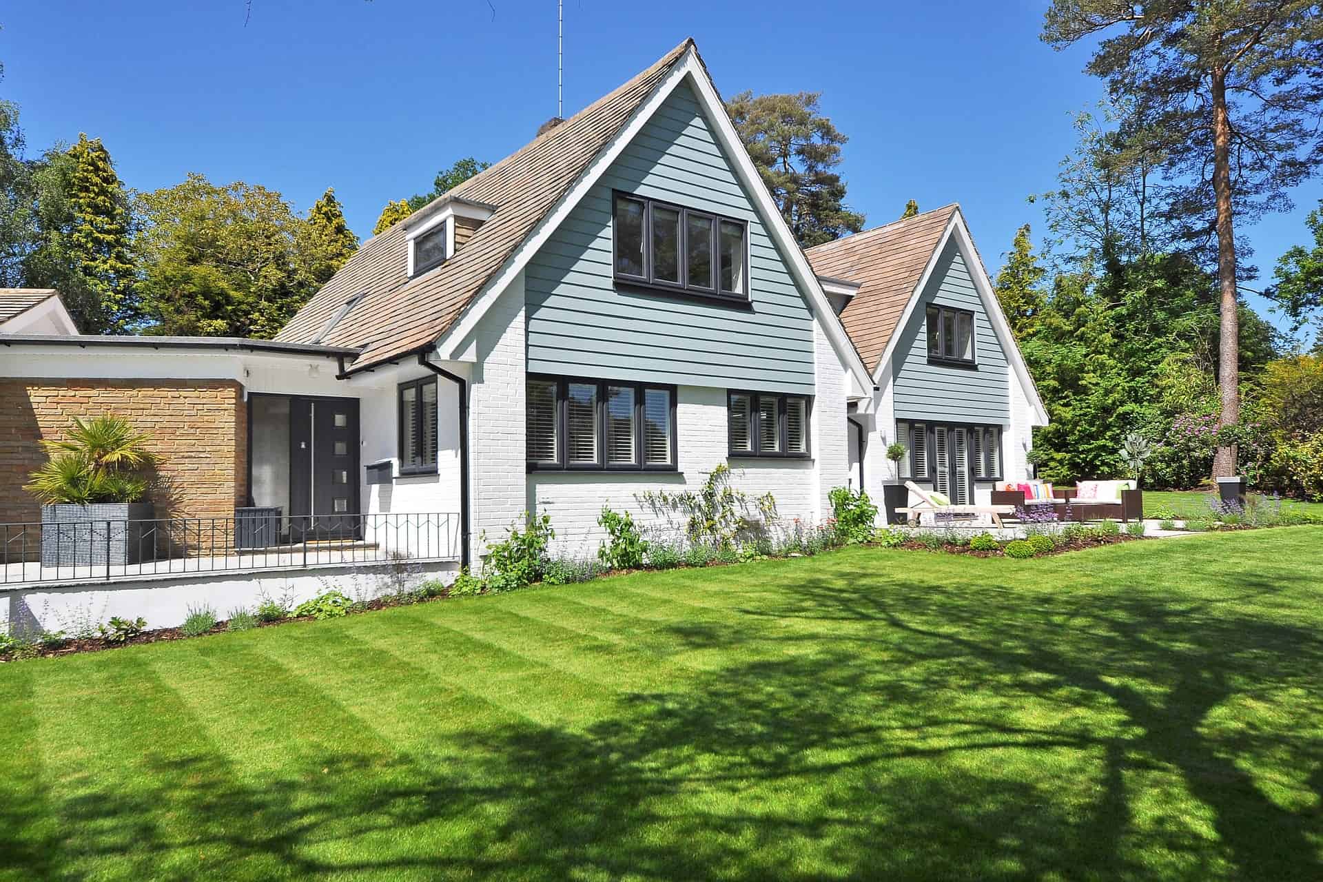 A house with painted lap siding and a mowed lawn